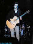 Stuart singing and playing acoustic guitar